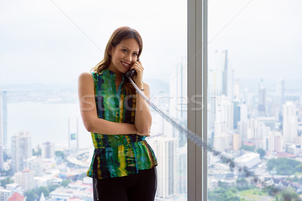 2 Young Latina Businesswoman With Wired Telephone In Modern Offi Stock photo © diego_cervo