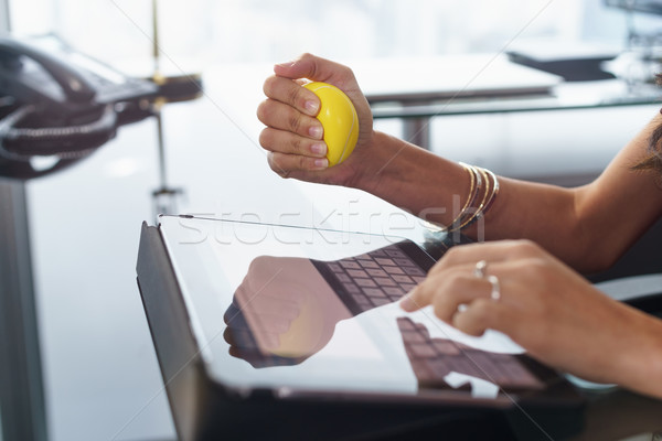 Stressed office worker with anti stress ball types email Stock photo © diego_cervo