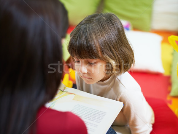 female teacher reading book to little girl Stock photo © diego_cervo