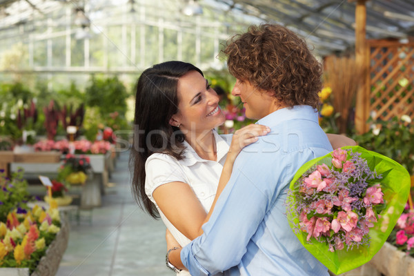 couple hugging in flower nursery Stock photo © diego_cervo