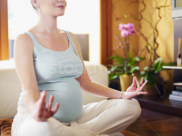 Stock photo: pregnant woman doing yoga at home