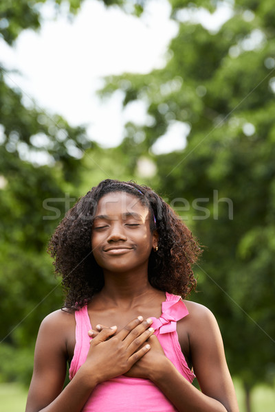 Portrait of black girl in love daydreaming and smiling Stock photo © diego_cervo