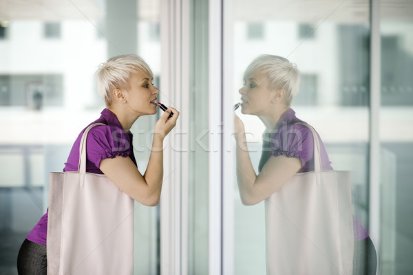 young business woman applying makeup in the street Stock photo © diego_cervo