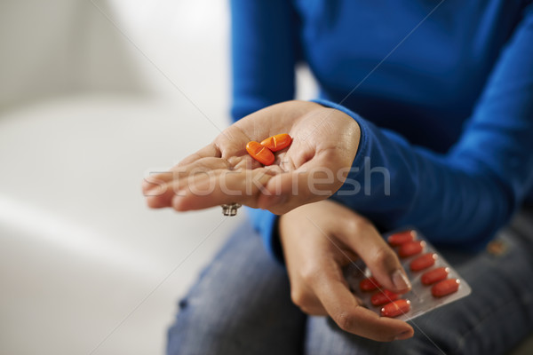 asian woman holding pills and medicine in hand Stock photo © diego_cervo