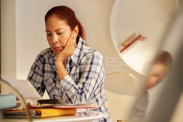 Stock photo: Angry Senior Woman Paying Bills And Filing Federal Tax Return