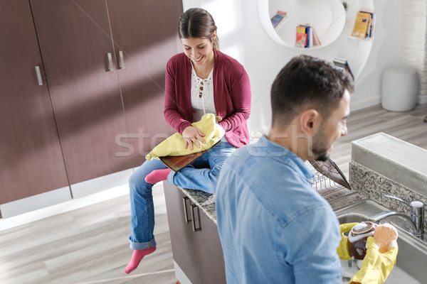 Man And Woman Doing Home Chores In Kitchen Stock photo © diego_cervo
