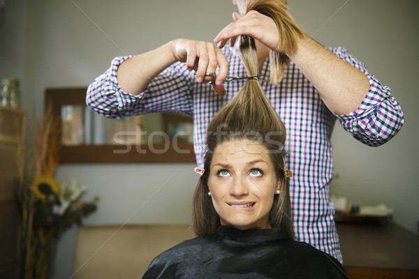 nervous woman in hairdresser shop cutting long hair Stock photo © diego_cervo