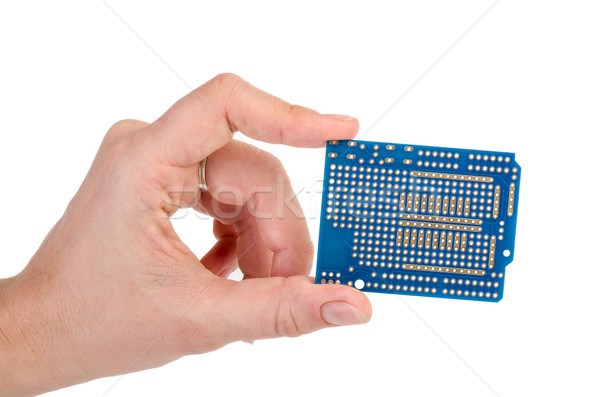 Blue prototyping PCB in a hand Stock photo © digitalr