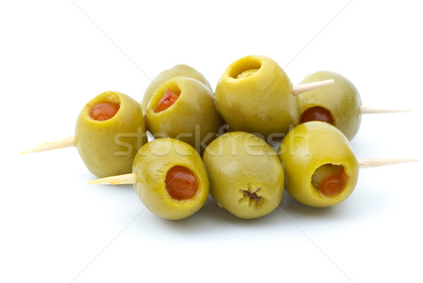 Some olives stuffed with pepper on a wooden toothpicks Stock photo © digitalr