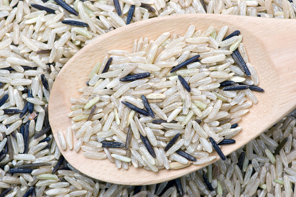 Raw white and black uncultivated rice and wooden spoon Stock photo © digitalr