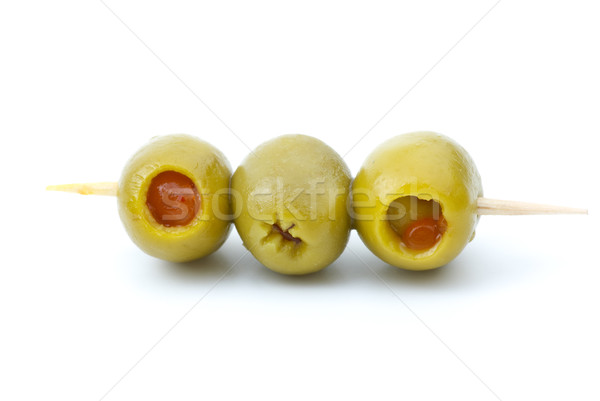 Some olives stuffed with pepper on a wooden toothpick Stock photo © digitalr