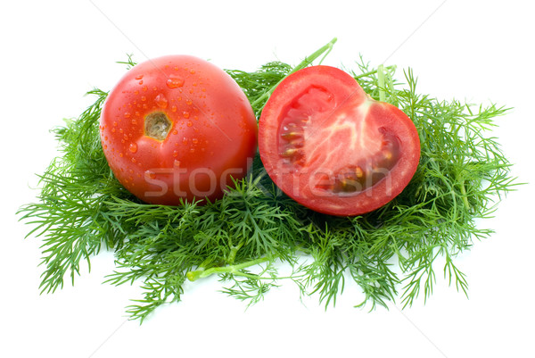 Whole and half of tomato over some dill Stock photo © digitalr