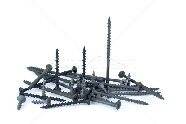 Stock photo: Some standing and pile of different screws