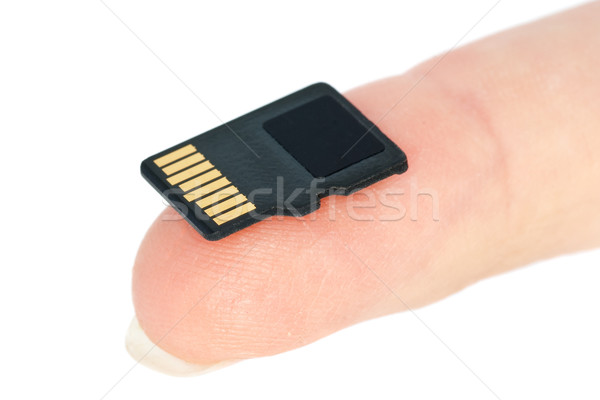 Minúsculo flash memoria tarjeta punta del dedo aislado Foto stock © digitalr