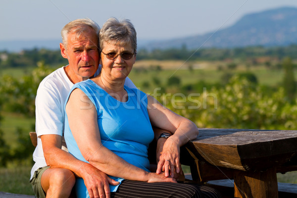 Idős pár idős pár ül pad család Stock fotó © digoarpi