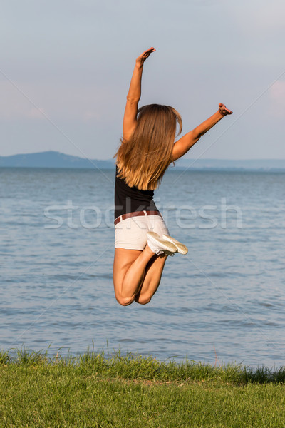 Happy girl jumping Stock photo © digoarpi