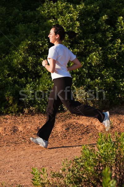 Fiatal lány fut kint élvezi mozgás nő Stock fotó © digoarpi
