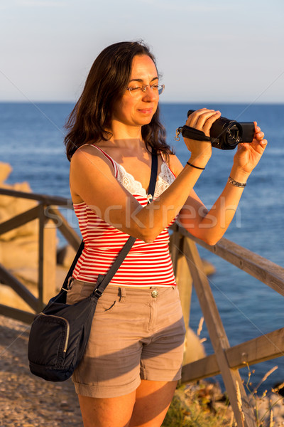 Pretty girl shooting a movie with camcorder Stock photo © digoarpi