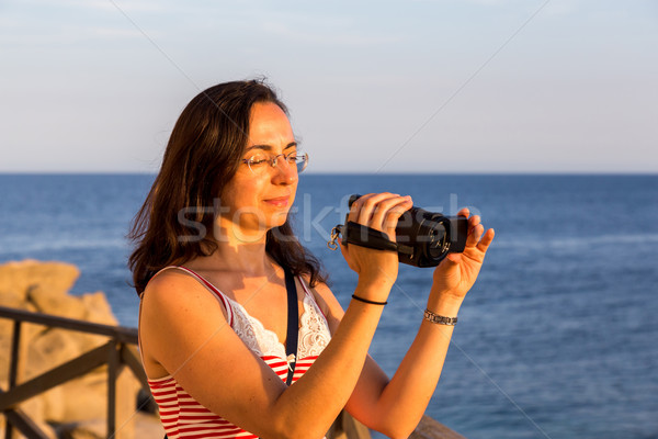 Pretty girl shooting a movie with camcorder Stock photo © digoarpi