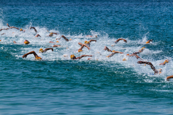 Triatlon sportolók vetélkedő sport tenger óceán Stock fotó © digoarpi