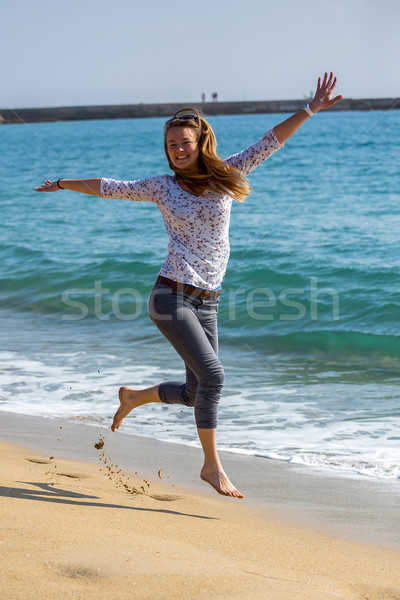 Pretty girl jumping near the lake Stock photo © digoarpi