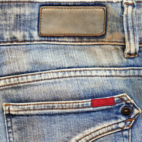 Stock photo: Leather and cotton labels on jeans