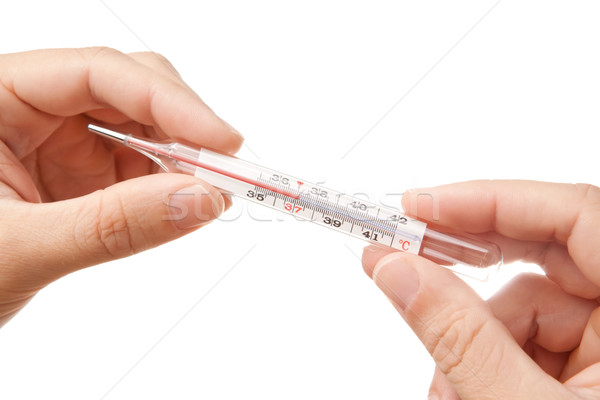 Hands holding thermometer showing 37'C Stock photo © Dinga