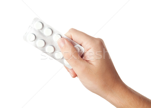 Kéz tart fehér tabletták orvosi drogok Stock fotó © Dinga