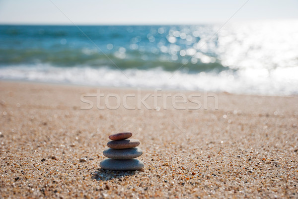 Stack of pebble stones on the beach Stock photo © dinozzaver