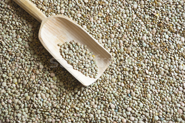 Raw lentil with wooden scooper Stock photo © dinozzaver