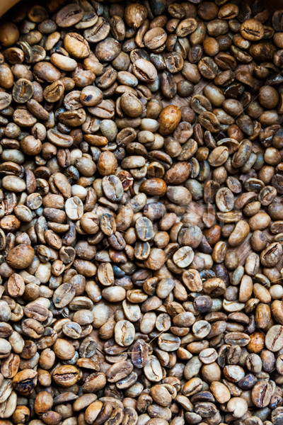 Dry and not roasted coffee beans close up Stock photo © dinozzaver