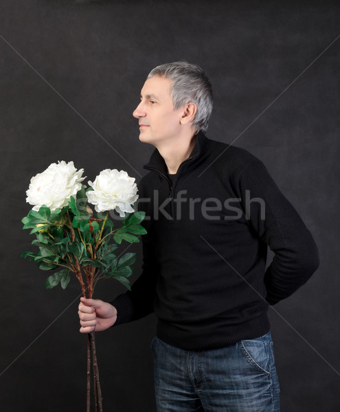 Man hiding a bouquet of flowers Stock photo © Discovod