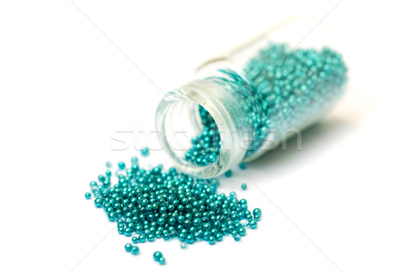 Small Glass Jar filled with Green Balls of Bead Stock photo © Discovod