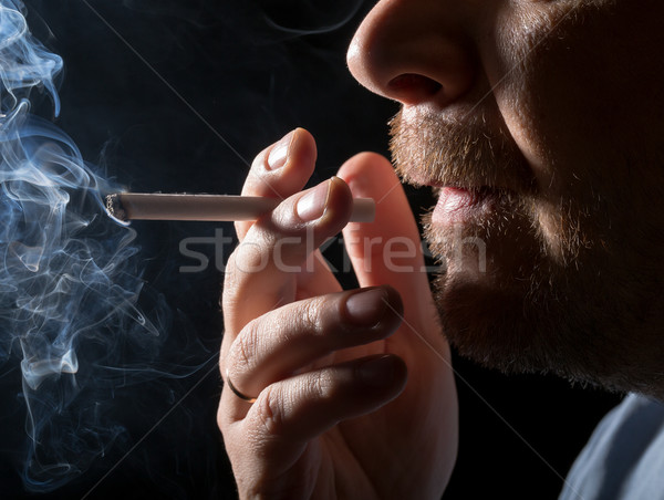 Stock photo: Portrait man smoking cigarette