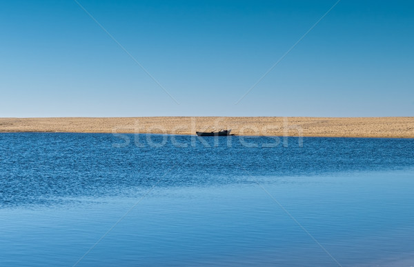 Solo Rowboat Moored on Sandy Beach Stock photo © Discovod