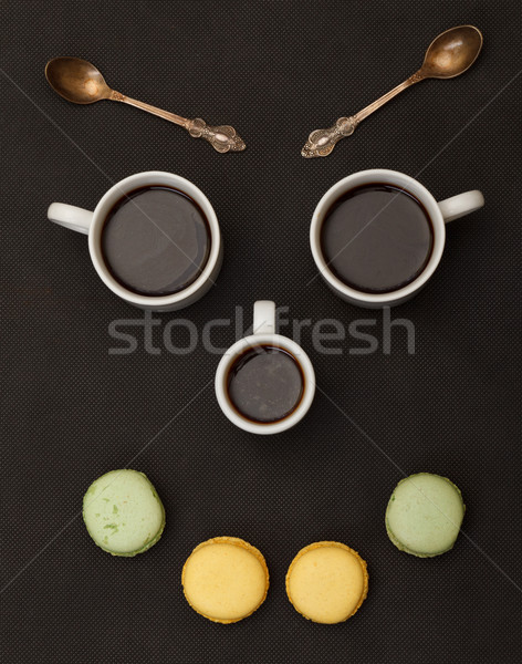 Tree cups coffee and macaroon arranged in happy face Stock photo © Discovod