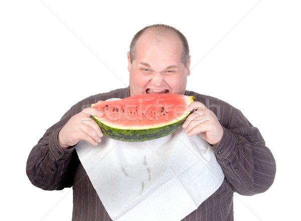 Stock photo: Obese man eating watermelon