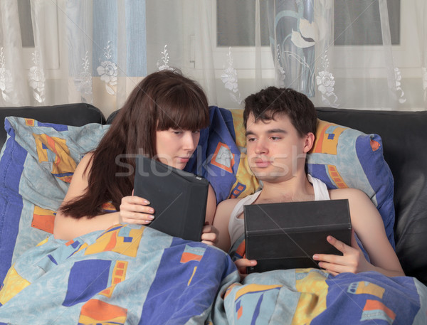Young couple using tablet PC in their bed Stock photo © Discovod
