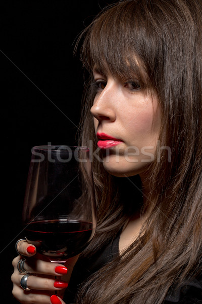 Young woman with red wine from a glass Stock photo © Discovod