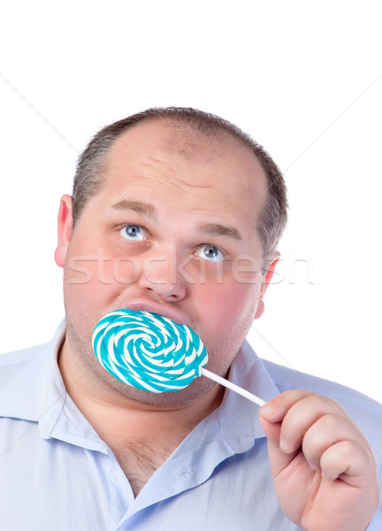 胖子 藍色 襯衫 吃 棒糖 孤立 商業照片 © Discovod