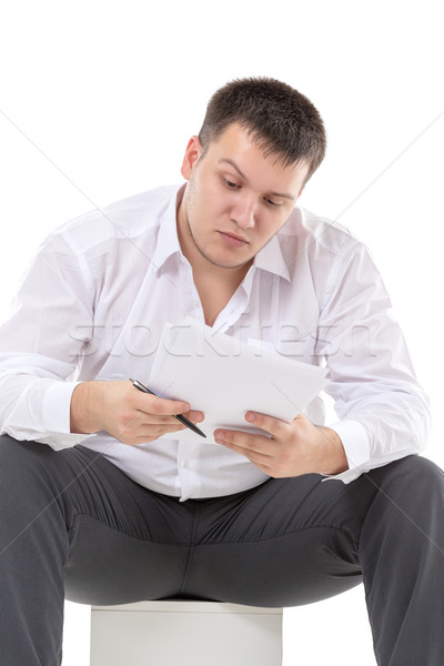 Businessman reading a report with scepticism Stock photo © Discovod