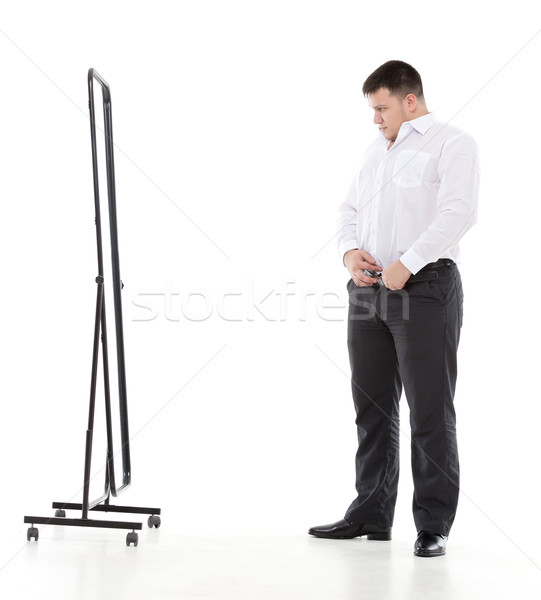 Overweight man admiring himself in a mirror Stock photo © Discovod