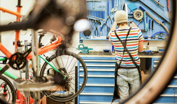 Bike mechanic preparing racing bicycles in workshop - Young man  Stock photo © DisobeyArt