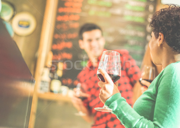 Happy friends toasting red wine at winery pub restaurant - Young Stock photo © DisobeyArt