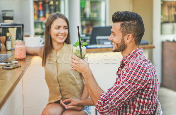 Young couple drinking aperitif cocktails at fashion bar restaura Stock photo © DisobeyArt