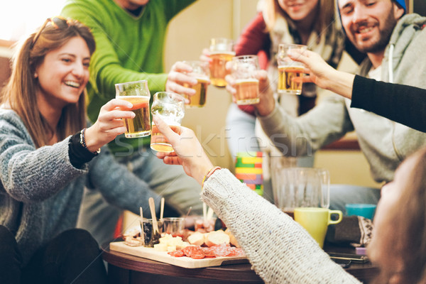 Group of happy friends cheering with beer after skiing day in ba Stock photo © DisobeyArt