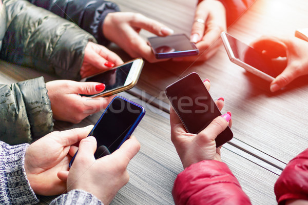 Group of friends having fun together with smartphone - Closeup o Stock photo © DisobeyArt