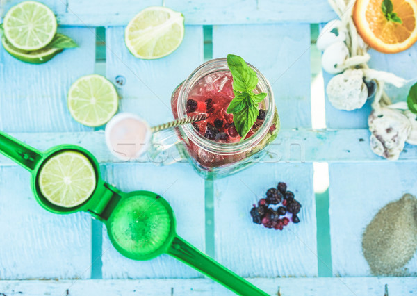 Stock photo: Top view of berries mojito on blue wood bar counter with lime sq