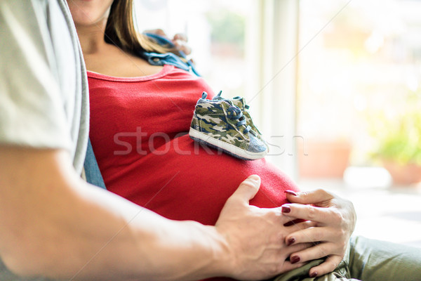 Young woman mum holding father hand on her abdomen with baby sho Stock photo © DisobeyArt
