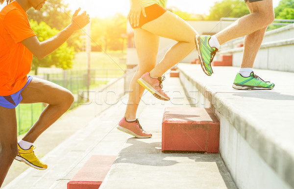 Stock photo: Runners training in stadium on terrace stairs with back sun ligh